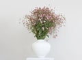 Pink flower bouquet in white vase on gray interior. Minimalist still life. Light and shadow nature horizontal background Royalty Free Stock Photo