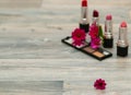 Pink flower on the cosmetic makeup table. Dressing table. Cosmetic composition. Make the concept of the table. Flat lying, front v Royalty Free Stock Photo