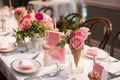 Pink flower design on the served restaurant table for Sunday girly brunch party. Royalty Free Stock Photo