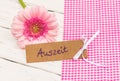 Pink flower with gift tag with german word Auszeit means relax Royalty Free Stock Photo