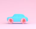 Pink flower layout wheel and car blue on pink pastel background. Royalty Free Stock Photo