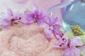 Pink flower rounding pink bath salt with etheric oil in a bottle