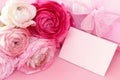 Pink flowers, blank card and gift box.