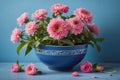 Pink Flowers in Blue Bowl on BlueWalled Surface Royalty Free Stock Photo