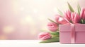 Pink flowers bouquet. Spring tulips with gift box over dreamy bokeh light background