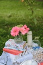 Pink flowers gerbera and green hydrangea in a glass vase, a candle, the inscription `love` in Russian and a decorative vase with Royalty Free Stock Photo