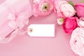 Pink flowers, gift box and empty tag. Royalty Free Stock Photo