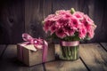 Pink flowers with a gift on wooden table, for mother\'s day. Ai generative