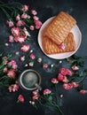 Pink flowers, puff pastries and coffee on a dark background, Bush roses, Blog style, Flatlay, Floral, Postcard