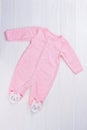 Pink footed baby girl pajama on wood