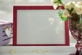 Pink frame mock up with sunlight and wineglass with white roses. Selective focus