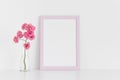 Pink frame mockup with pink roses in a glass vase on a white table.Portrait orientation Royalty Free Stock Photo