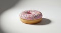 Pink frosted donut with colorful sprinkles, casting a soft shadow on a white surface Royalty Free Stock Photo