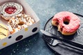 Pink frosted donut on dark background