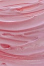 Pink frosting close-up, sweet whipped cream texture