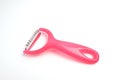 Pink fruit peeling device on a white ground Royalty Free Stock Photo