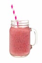 Pink fruit smoothie in mason jar glass isolated on white