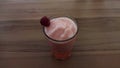 Pink Fruit Smoothie with Raspberry Garnish in Tall Glass on Wooden Surface Royalty Free Stock Photo
