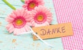 Beautiful pink bunch of flowers and card with german word, Danke, means thank you