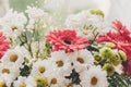 Pink gerbera,white daisy and green chrysanthemum in beautiful br