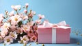 Pink gift box with cute spring pink flowers on the light blue background. International women's day, Mothers Day