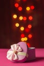 Pink gift box open shaped heart with Defocused bokeh colorful li