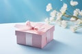 Pink gift box with ribbon bow and flower on blue background, Mothers day and Valentine present promotion offer concept. Generative