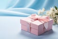 Pink gift box with ribbon bow and flower on blue background, Mothers day and Valentine present promotion offer concept. Generative