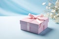 Pink gift box with ribbon bow and flower on blue background, Mothers day and Valentine present promotion offer concept. Generative Royalty Free Stock Photo