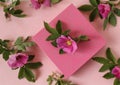 Pink gift box with rosehip flowers on a pastel background Royalty Free Stock Photo