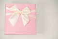 Pink gift box with tie on white background. Minimal concept.