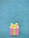 Pink gift box on teal green background. Vertical photo image. Royalty Free Stock Photo