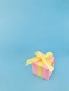 Pink gift box on blue background, vertical. Royalty Free Stock Photo