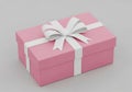 A pink gift box with white ribbon and bow on top for special occasions Royalty Free Stock Photo
