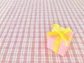 Pink gift box on red white Plaid background. Royalty Free Stock Photo