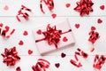 Pink gift boxes with red ribbons and bows, confetti hearts on a white background. Copy space Flat lay. Greeting card for Royalty Free Stock Photo