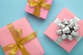 Pink gift boxes with silver and gold bow on blue background Royalty Free Stock Photo