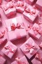 Pink gift group with ribbons on pink background.