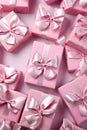 Pink gift group with ribbons on pink abstract background.