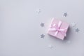 Pink gift or present box and stars confetti on pastel background top view. Flat lay composition for birthday, christmas or wedding Royalty Free Stock Photo