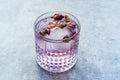 Pink Gin Tonic Cocktail with Dried Rose Buds and Ice in Glass Cup Royalty Free Stock Photo