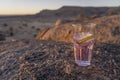 pink gin_tonic on rocks in desert, near Hobas, Namibia
