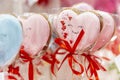 Pink gingerbreads in the shape of a heart in a festive package with a red bow