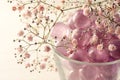 Pink glass marbles and blush gypsophila flowers as a feminine decoration for beauty, wellness and romantic interior concepts, copy