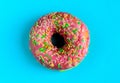 Pink glazed donut on blue background.Sweet Dessert.