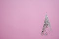 Pink glitter fir tree icon with star, shining glowing twinkled sparkled textured object, Christmas and New Year invitation and