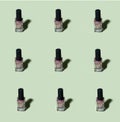 Pink glitter nail polish pattern on basil green background Royalty Free Stock Photo
