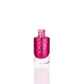 Pink glittering nail polish in glass bottle on white background isolated closeup, opened red sequin varnish, bright shiny magenta