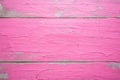 pink gloss paint with cracks on a wooden bench