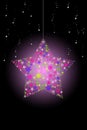 Pink glowing Christmas star hanging with snow